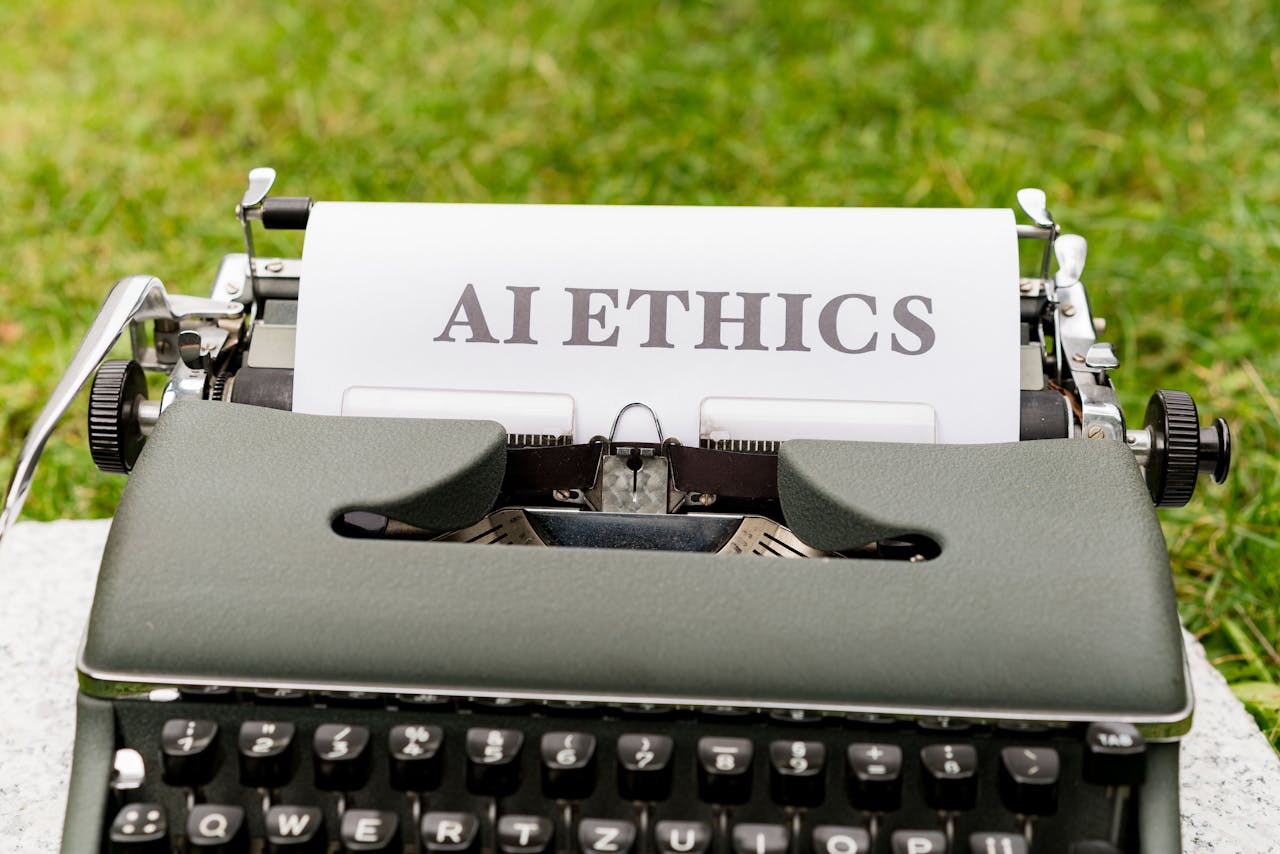 who-we-are A vintage typewriter outdoors displaying "AI ethics" on paper, symbolizing tradition meets technology.